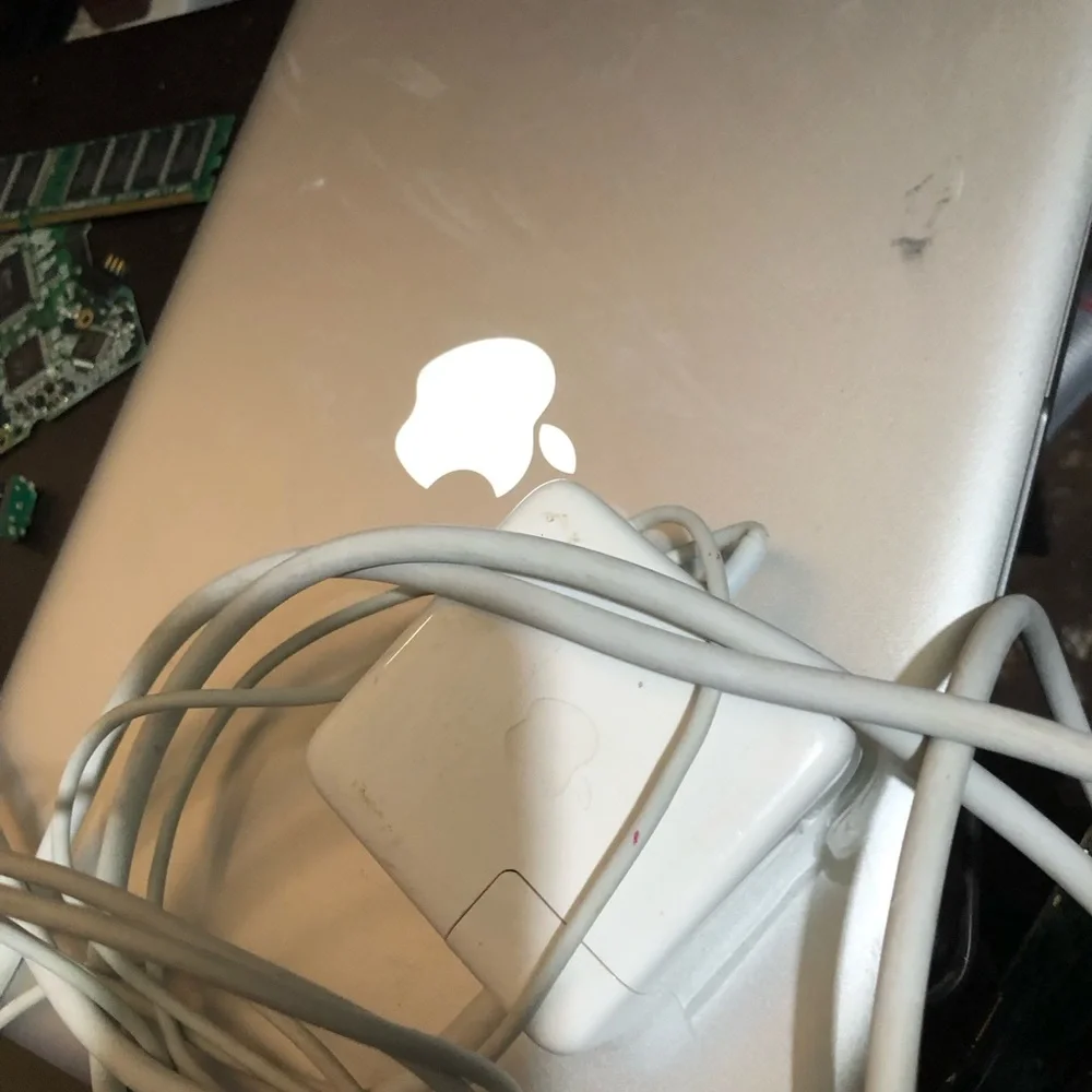 Apple MacBook with 4 chargers and dell laptop for parts